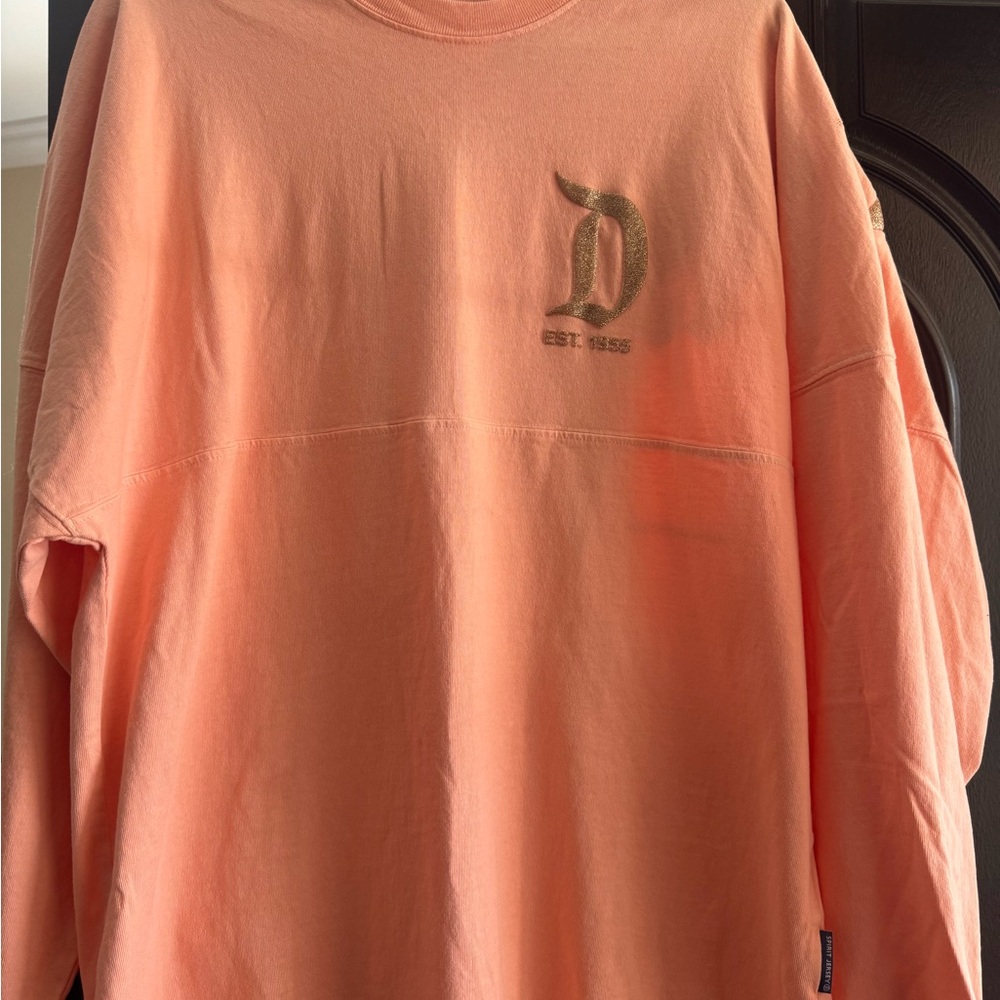 Disney Disneyland Peach Top with Gold Glitter Logo